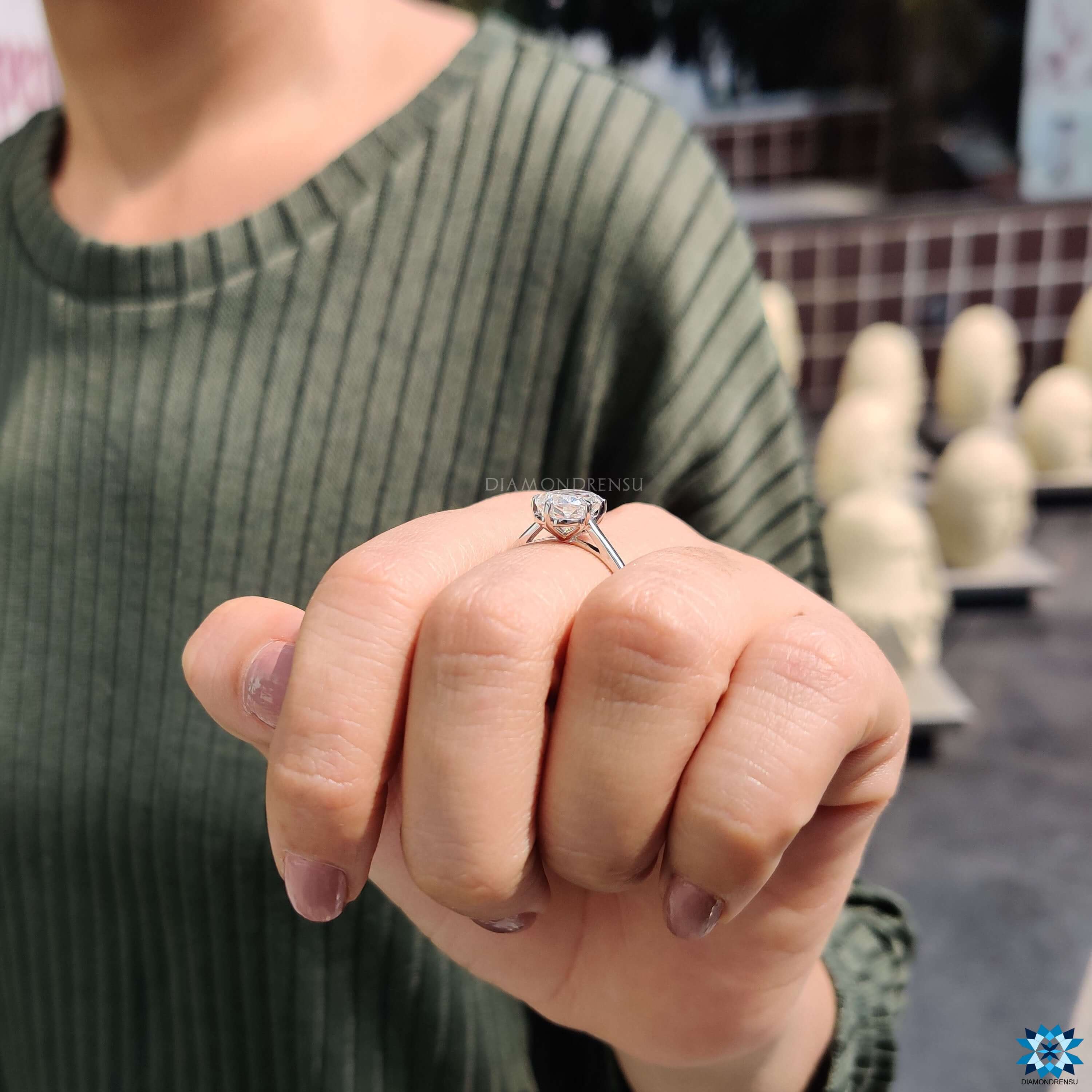 Custom engagement ring with solitaire criss cut design.