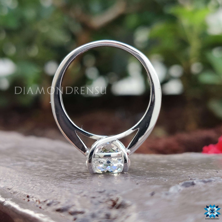 Custom moissanite ring with four-tab prong setting.