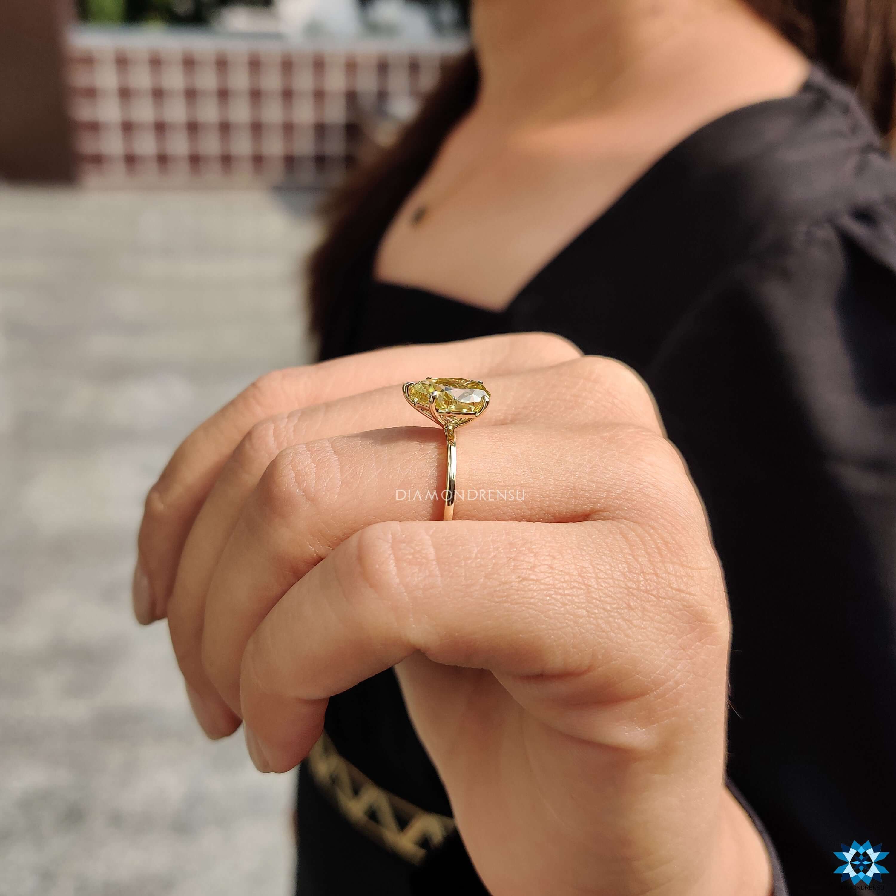 Buy moissanite ring with pear cut center stone.