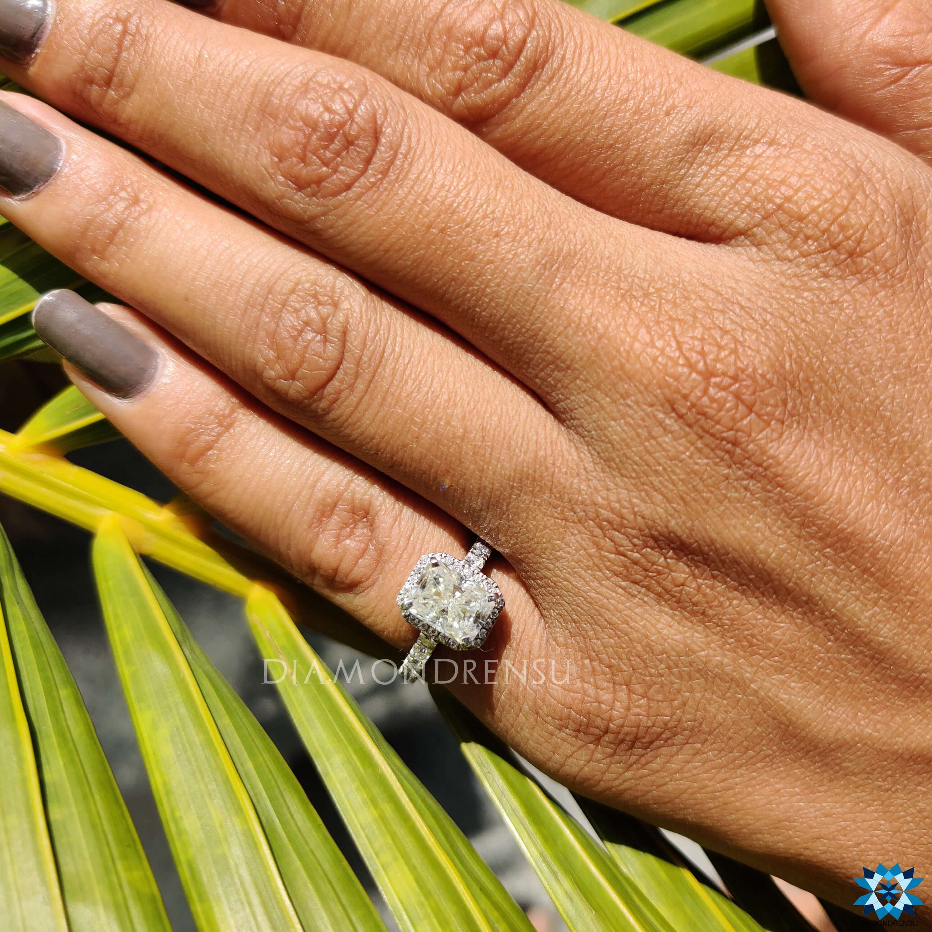 Elegant radiant moissanite ring with layered halo details.