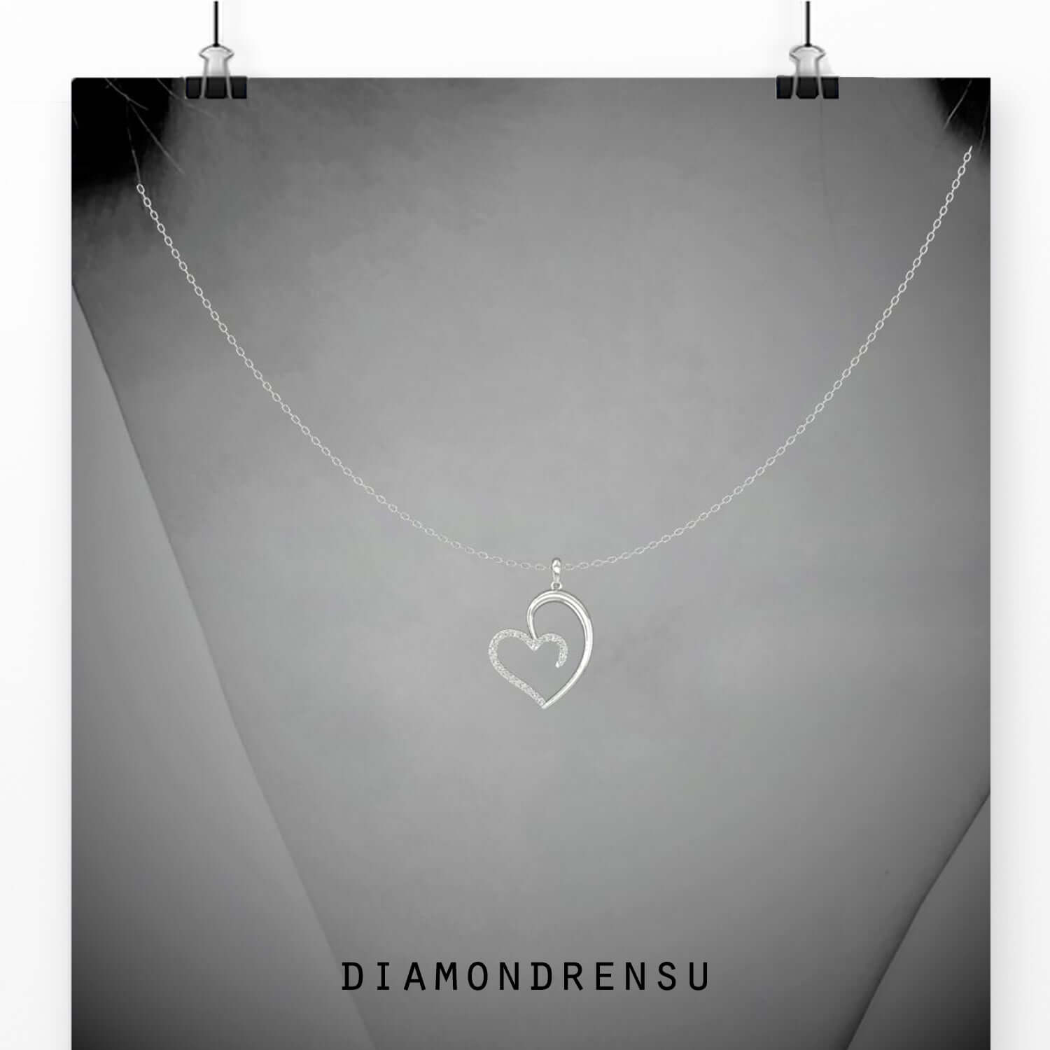 Elegant pendant with heart shape in white gold finish.