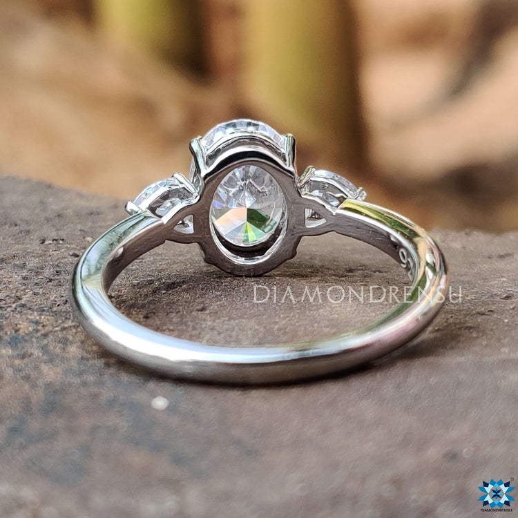 White gold ring with oval and pear moissanite stones.
