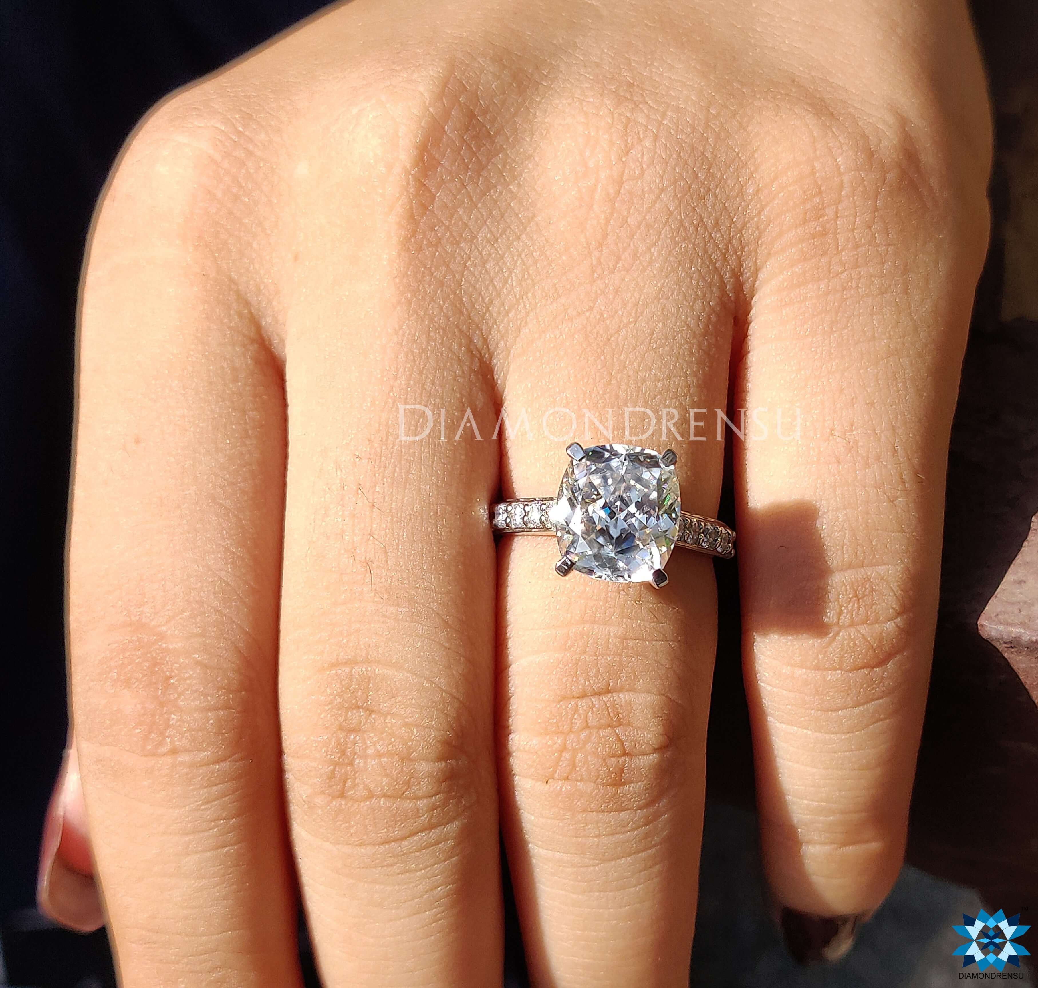 Pave engagement ring featuring a cushion cut diamond for a sparkling look.
