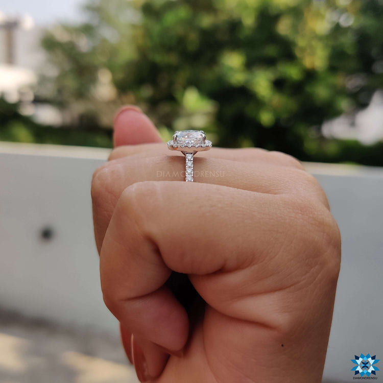 Handmade cushion Rensu ring with moissanite and halo accents.