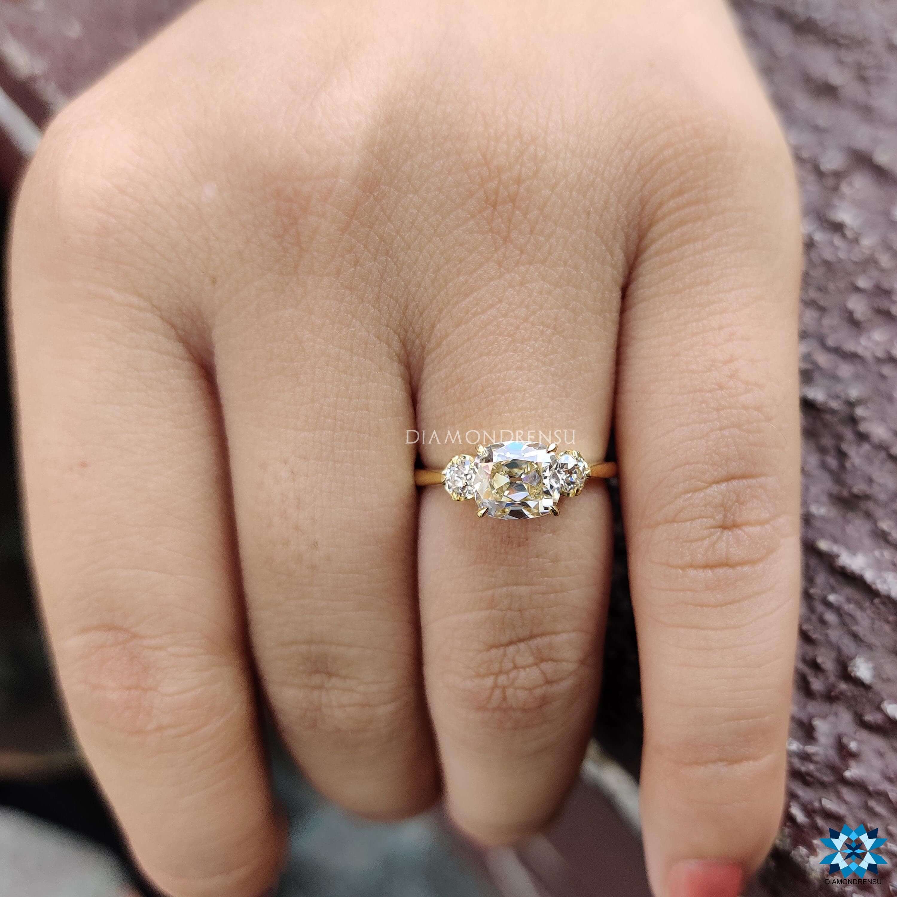 Old mine cushion cut engagement ring set in yellow gold with 4 claw prong setting.