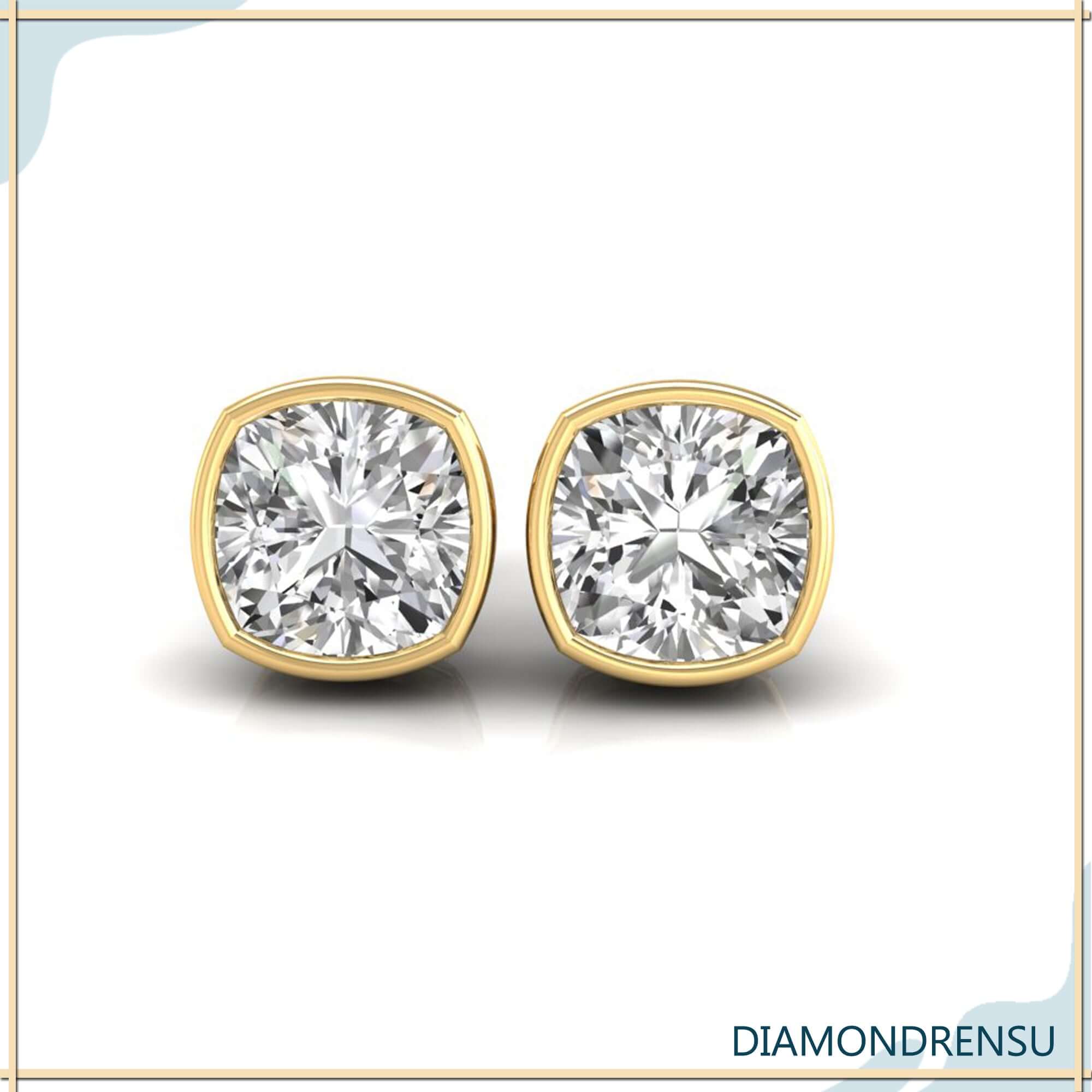 Gold stud earrings with cushion cut bezel set diamonds.