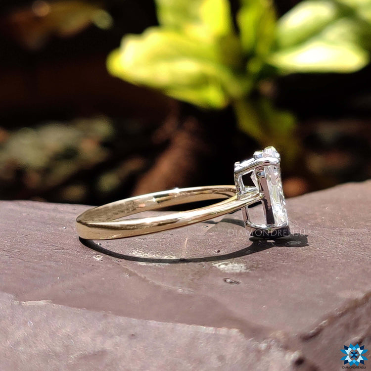 Yellow and white gold engagement ring with V prong setting.