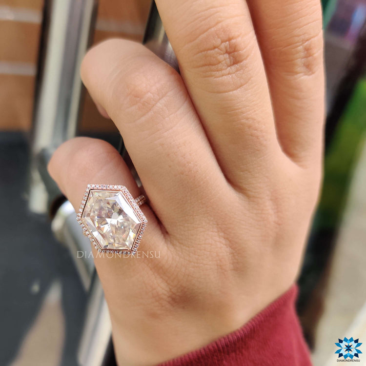Bezel set moissanite engagement ring with halo details.