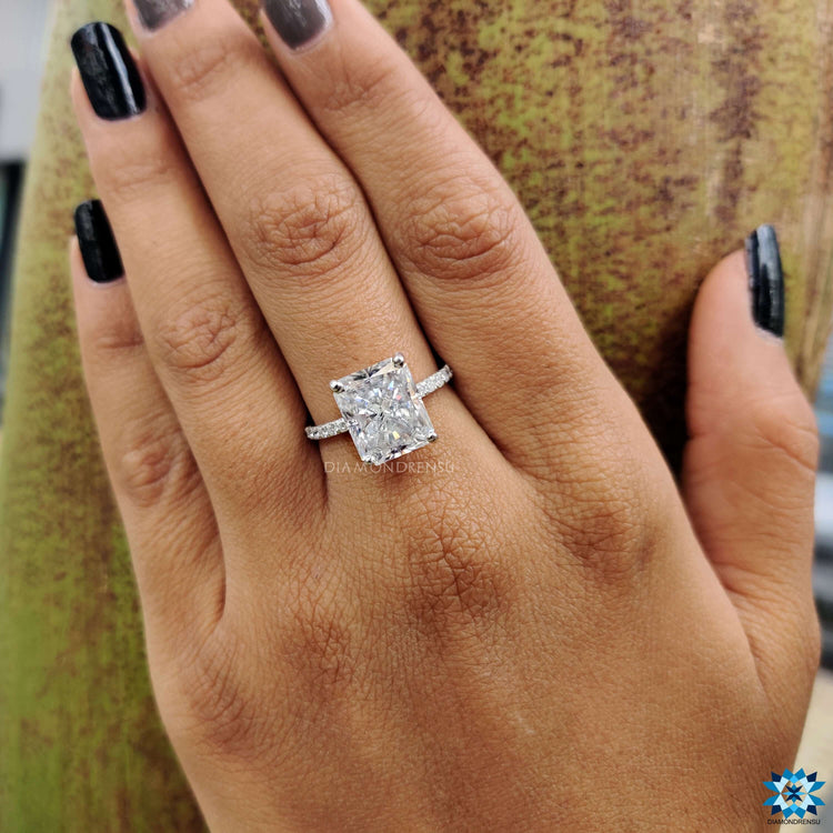 Prong setting moissanite ring with pave band.