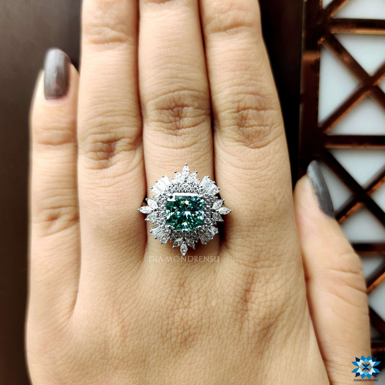 White gold ring with radiant cut moissanite and side accents.