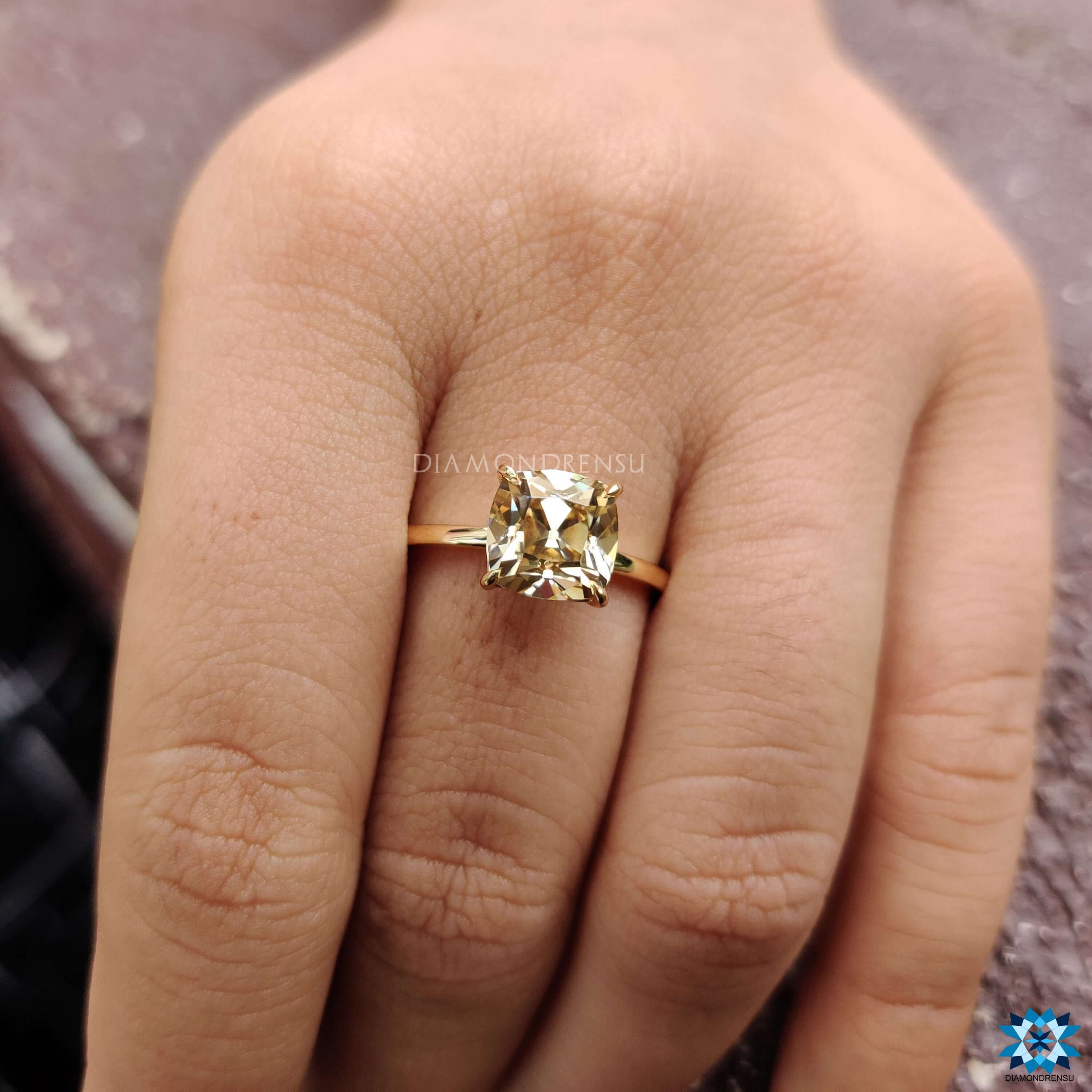 Cushion cut light yellow moissanite solitaire ring.