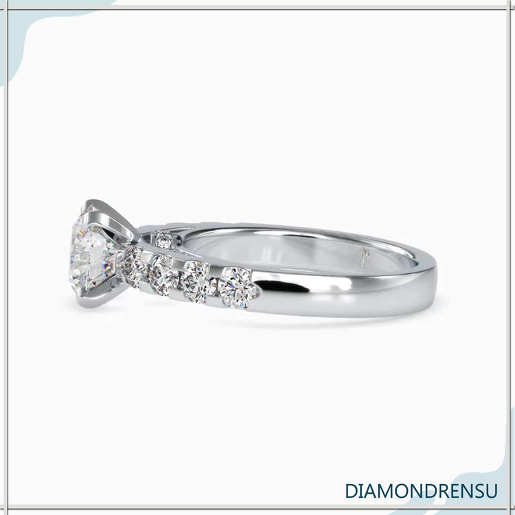 Rose gold ring featuring round cut diamond and pave accents.