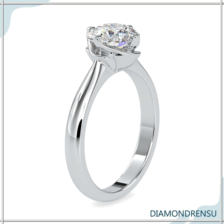 Buy diamond ring in classic four prong solitaire style.