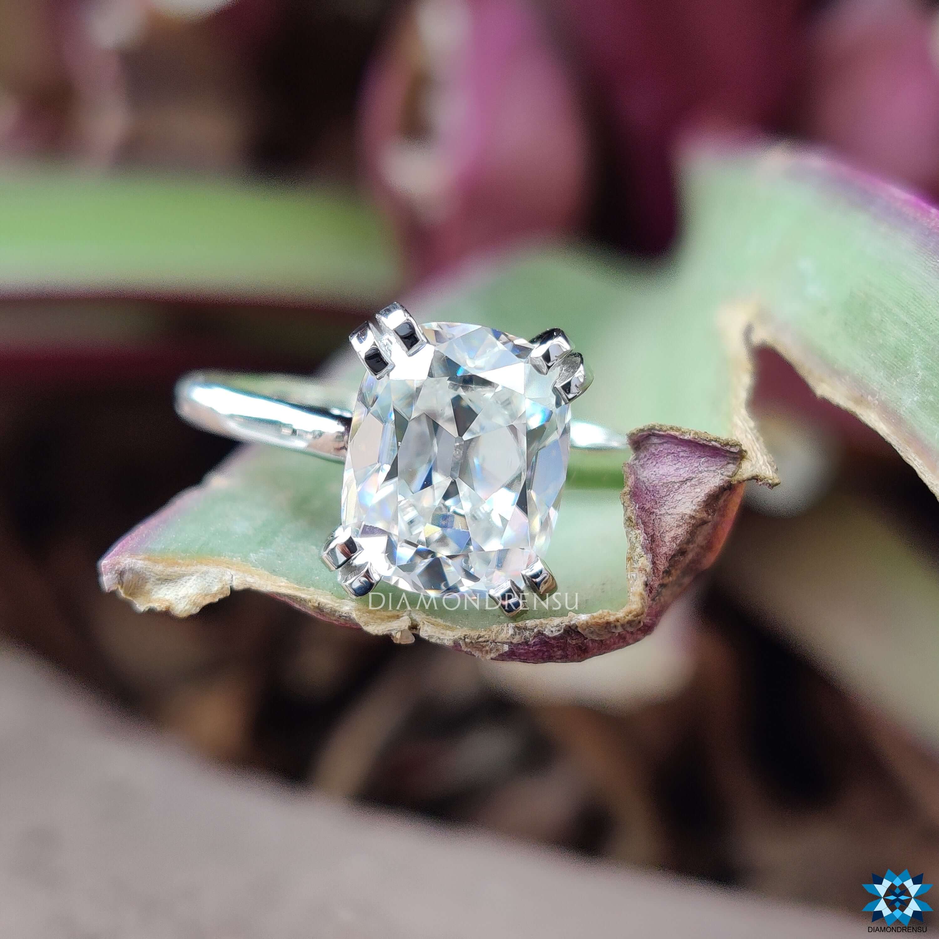 Elegant cushion cut solitaire moissanite ring in prong setting.