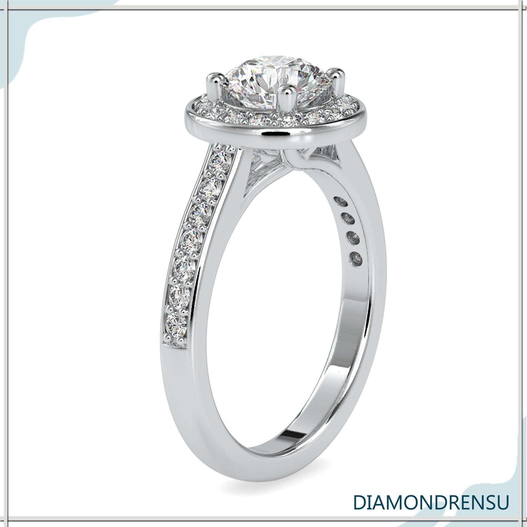 Simple diamond ring featuring halo setting and round cut band.
