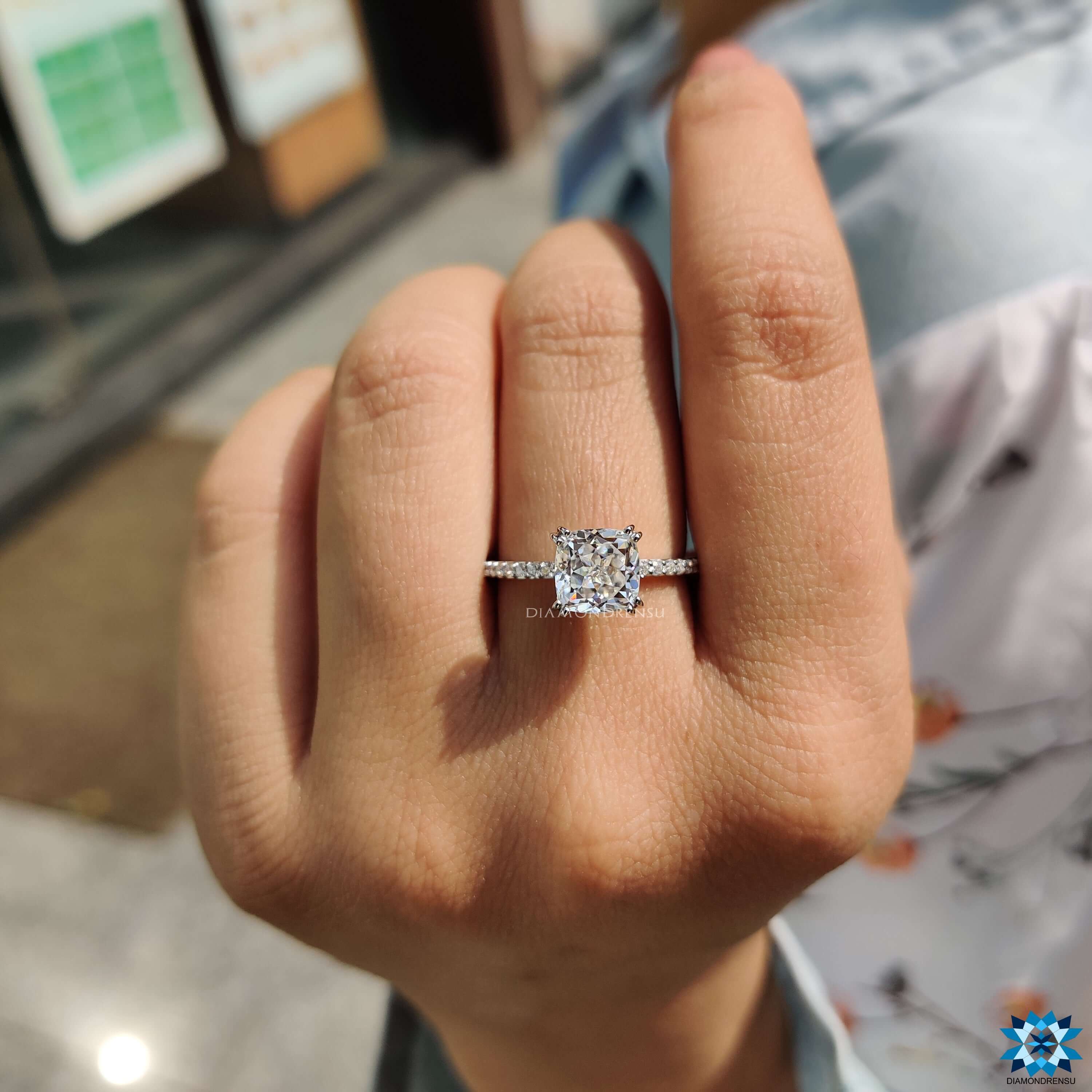 Cushion rensu cut moissanite in a hidden halo setting.