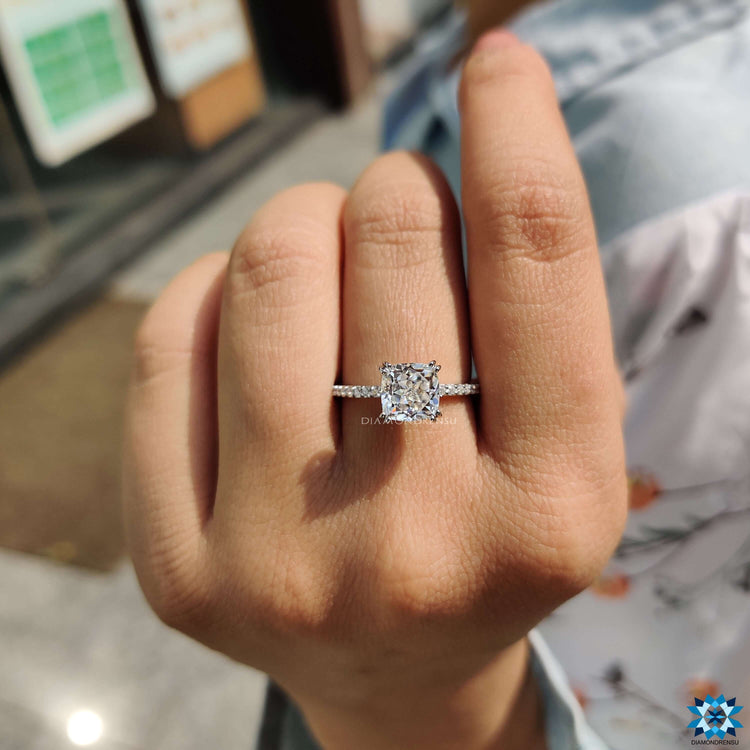 Cushion rensu cut moissanite in a hidden halo setting.