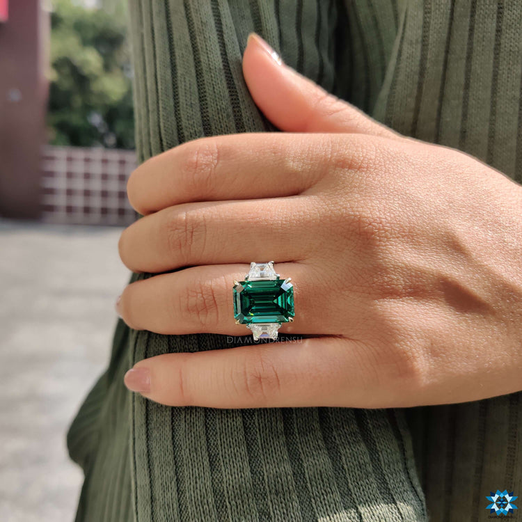 Emerald cut moissanite with trapezoid side stones.