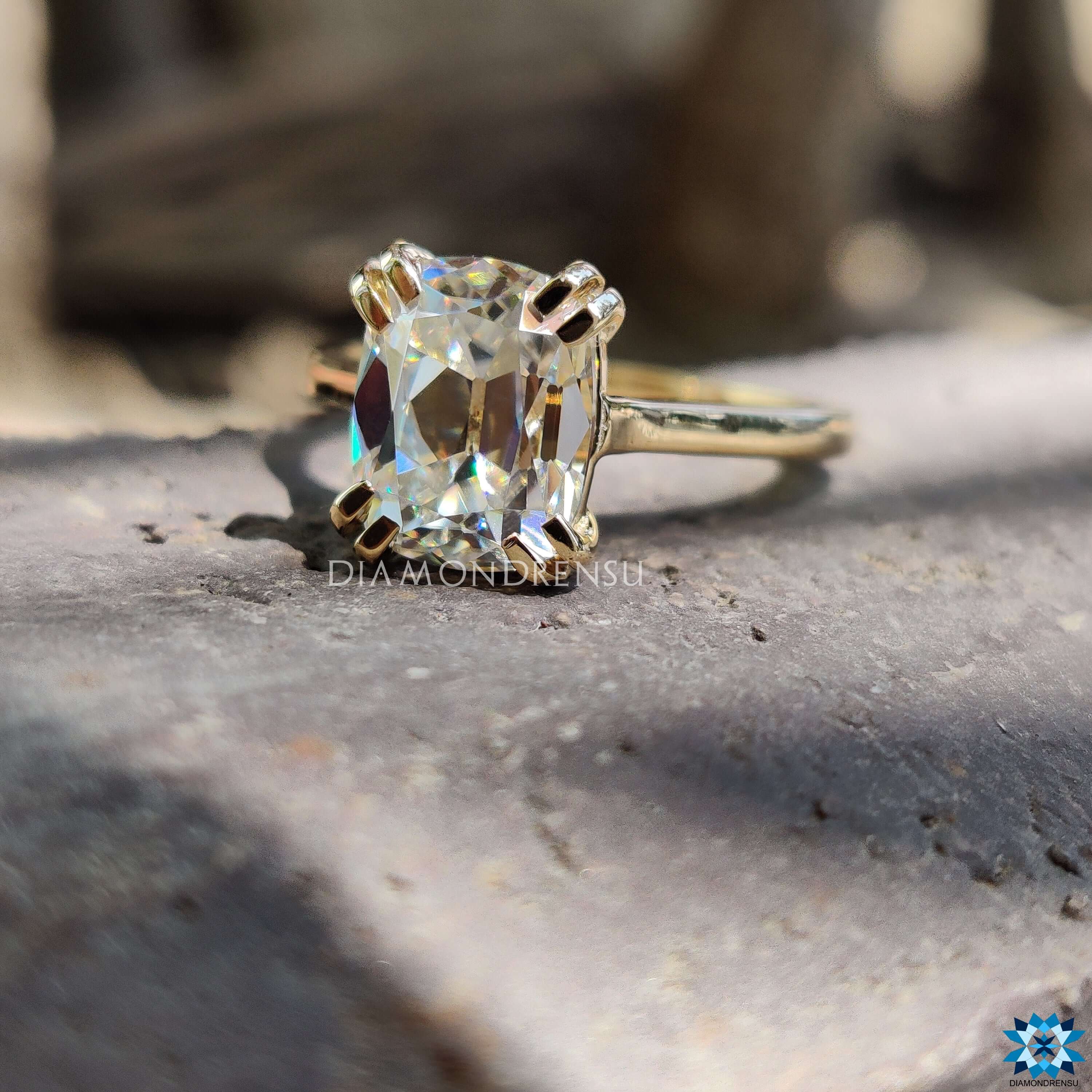 Handmade yellow gold ring with cushion cut moissanite.