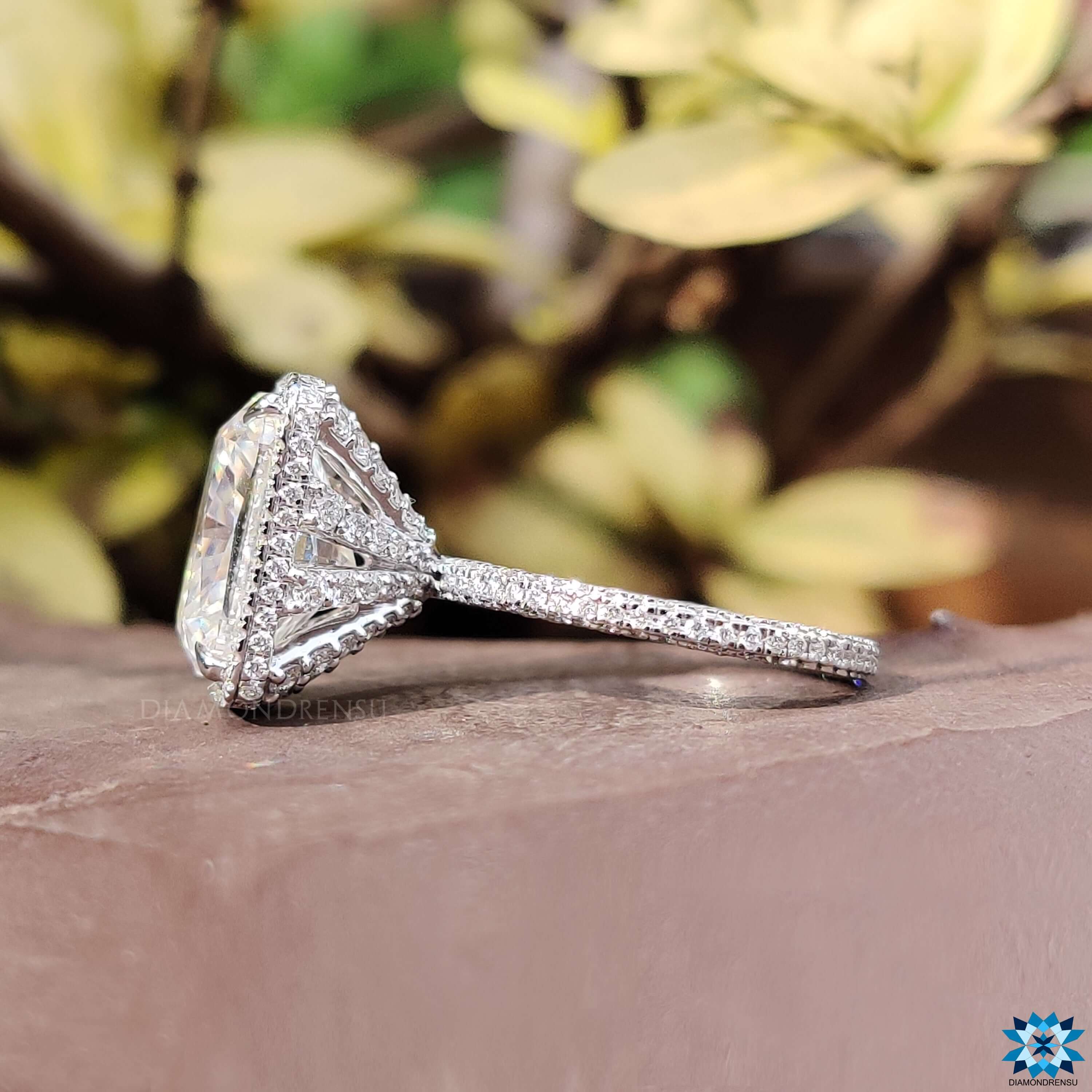 Three side pave set ring with cushion cut center stone.