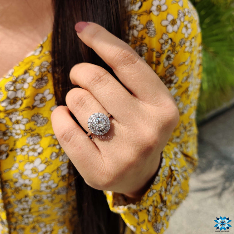 Cluster halo ring with round cut moissanite stones.