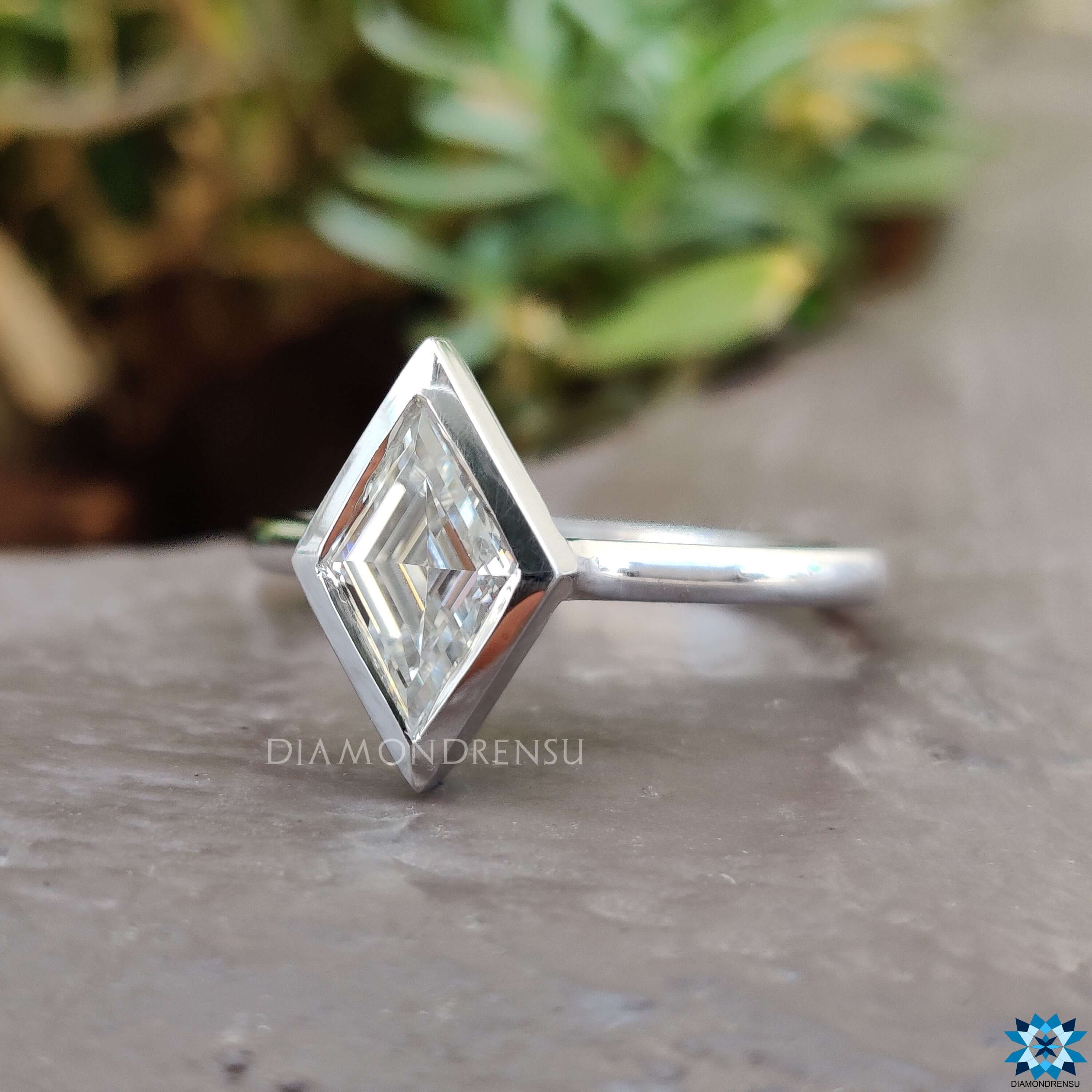 White gold bezel set solitaire engagement ring.