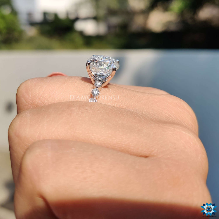 Unique engagement ring with floating pave stones and Portuguese moissanite centerpiece.