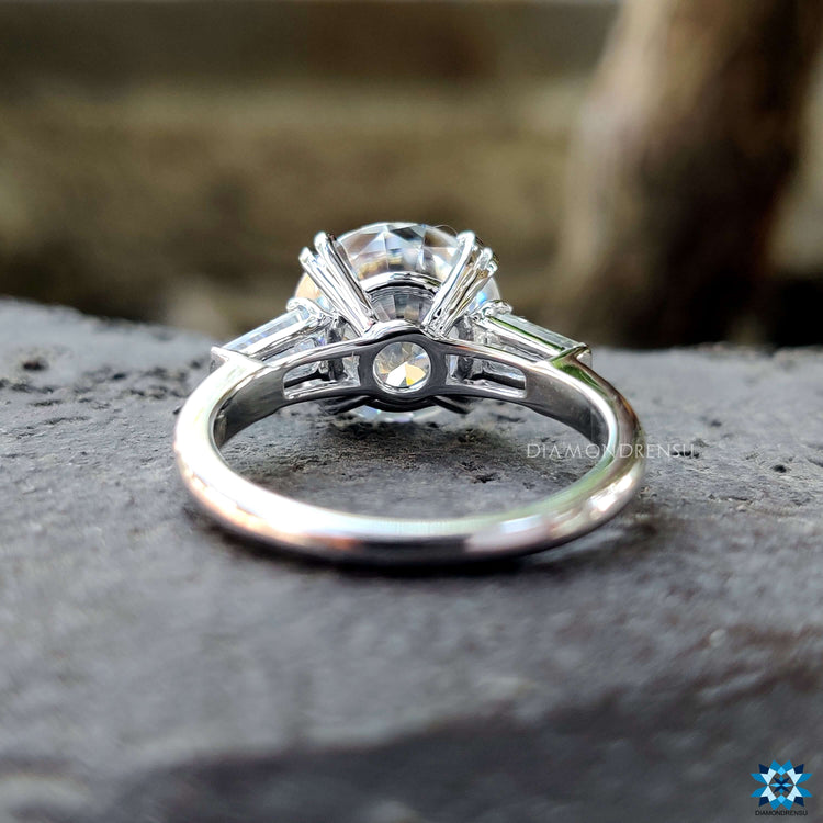 White gold moissanite ring with tapered side stones.