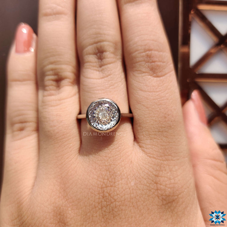 Solitaire engagement ring featuring Portuguese cut moissanite.