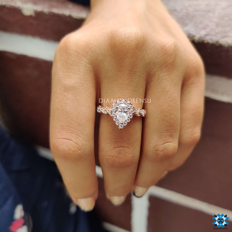 Elegant halo engagement ring with twisted pave shank.