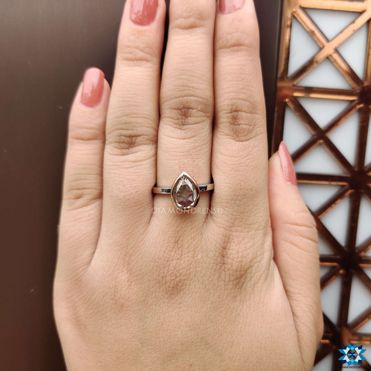 Pear cut rose cut solitaire ring with bezel setting.