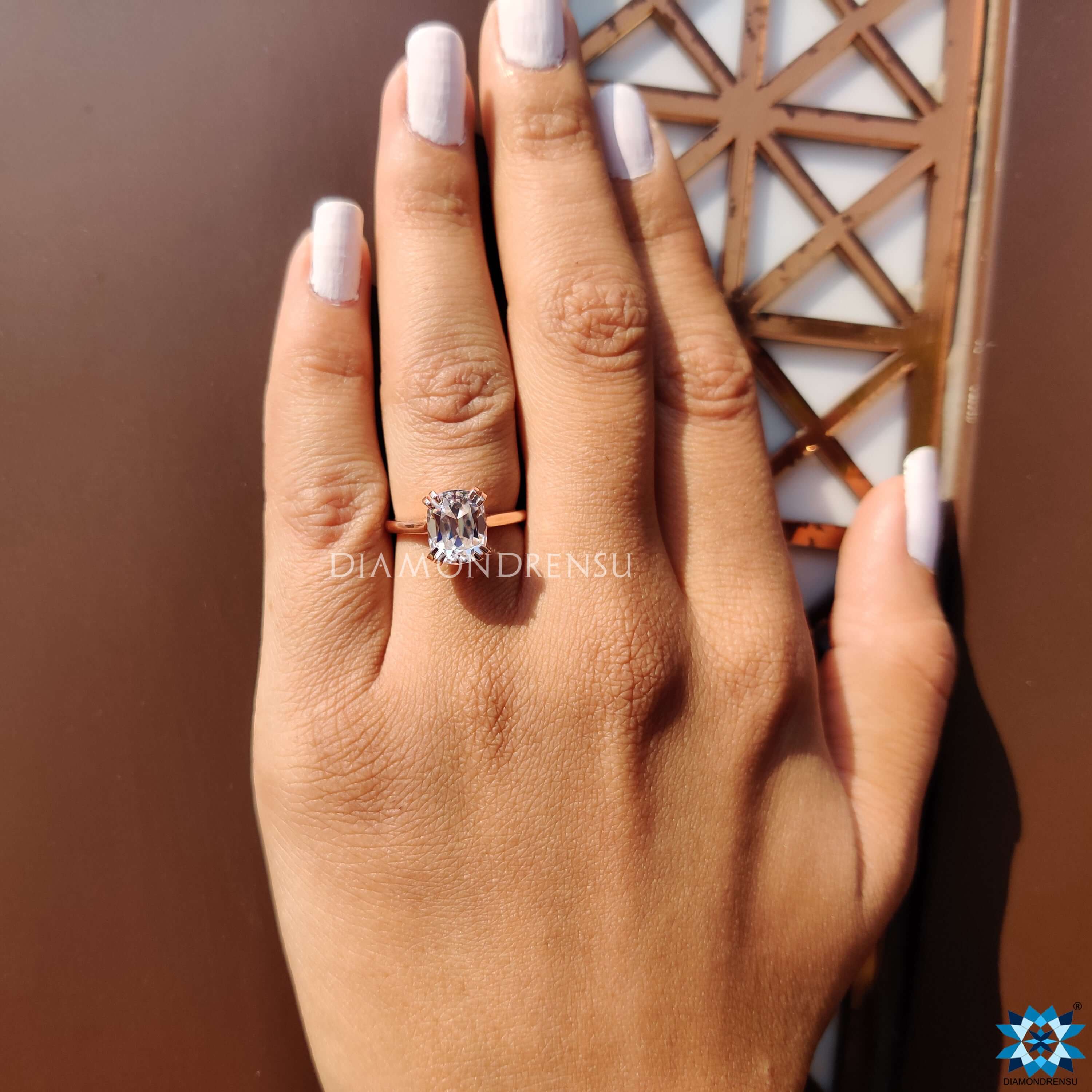 Solitaire engagement ring featuring elongated cushion moissanite.