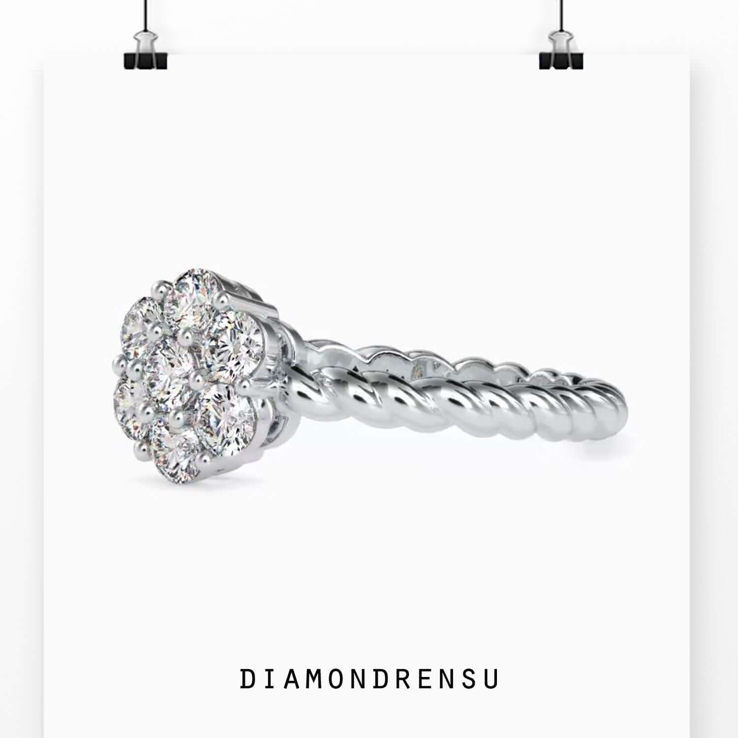 Rose gold twisted engagement ring with round cut centre and halo.