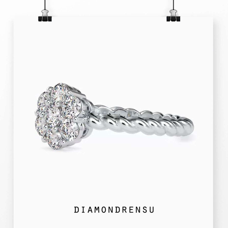 Rose gold twisted engagement ring with round cut centre and halo.