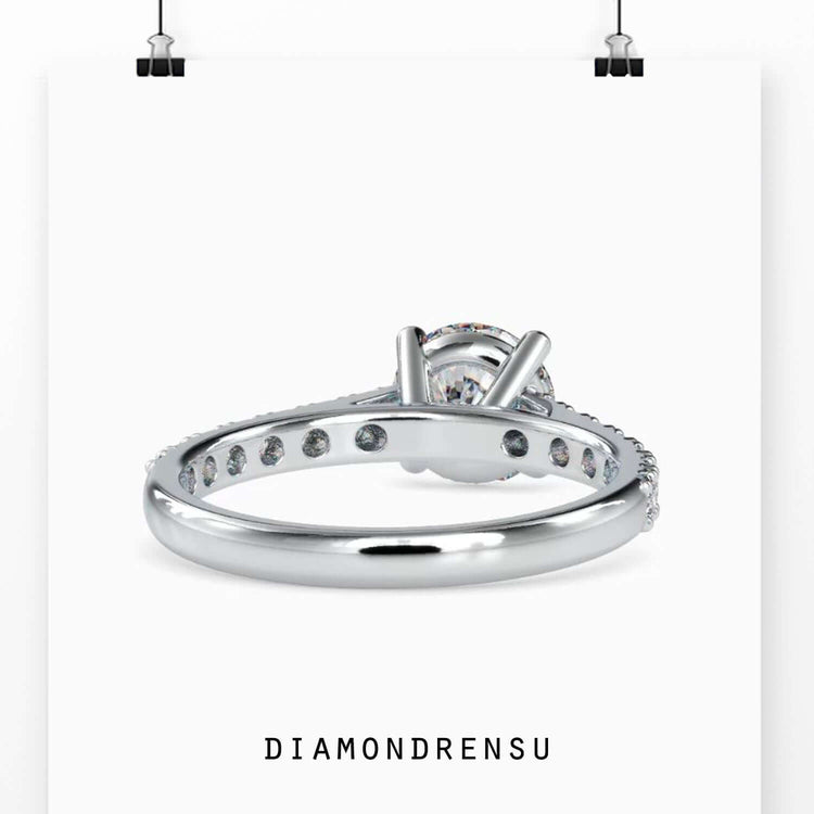 Custom engagement ring featuring round brilliant cut diamond.