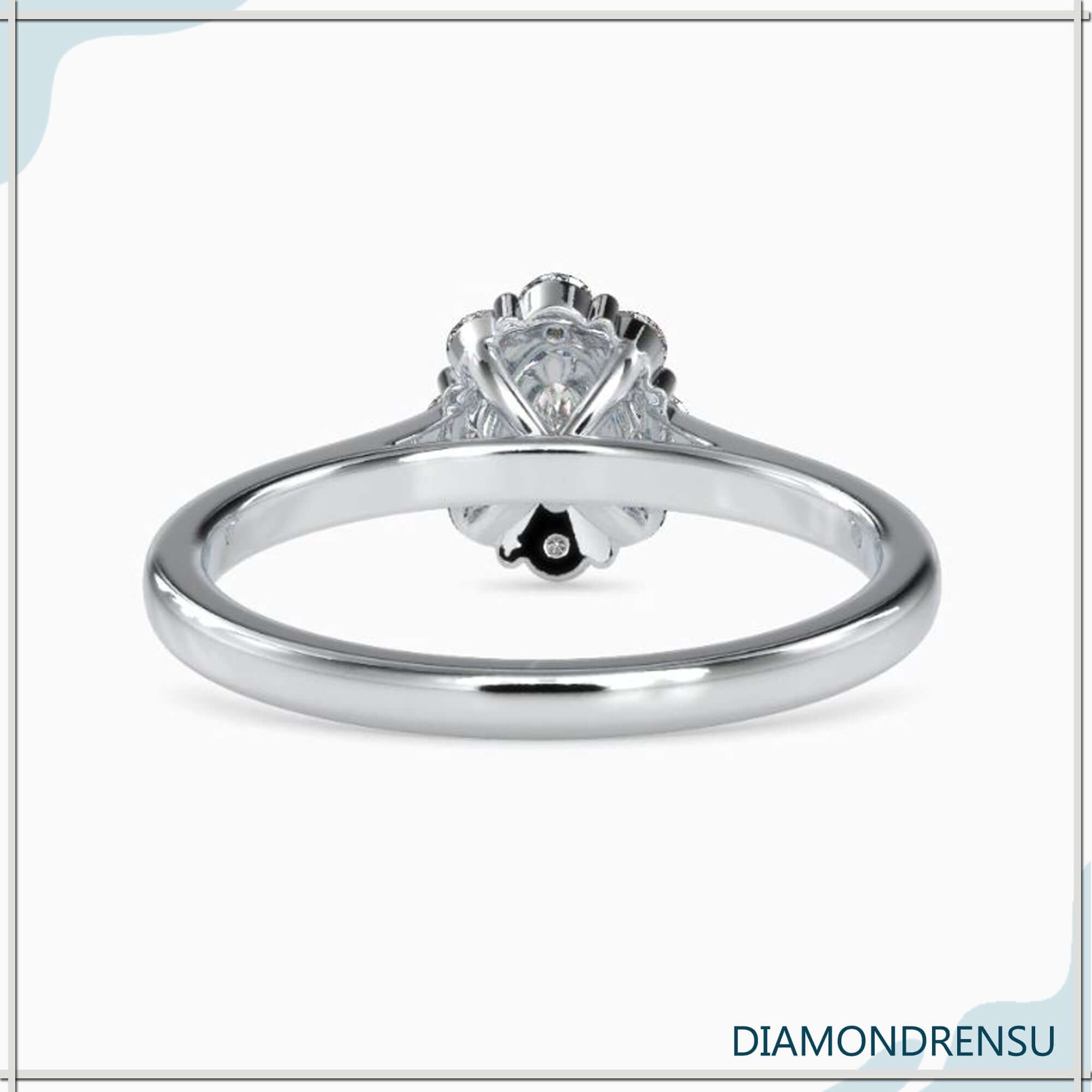 Diamondrensu UK engagement ring with cluster halo and oval centre.
