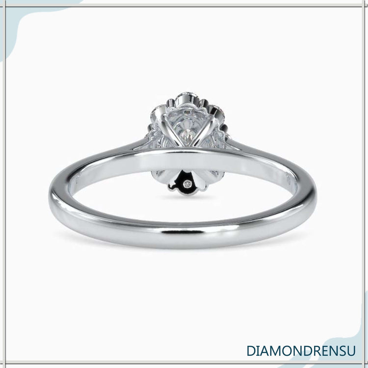 Diamondrensu UK engagement ring with cluster halo and oval centre.