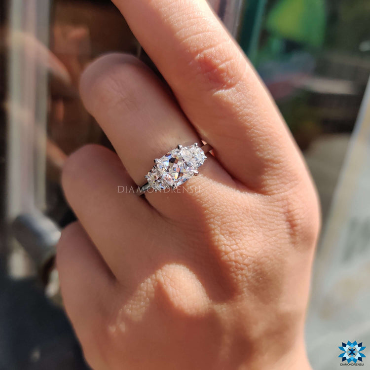 Moissanite engagement ring with half moon and cushion cuts.