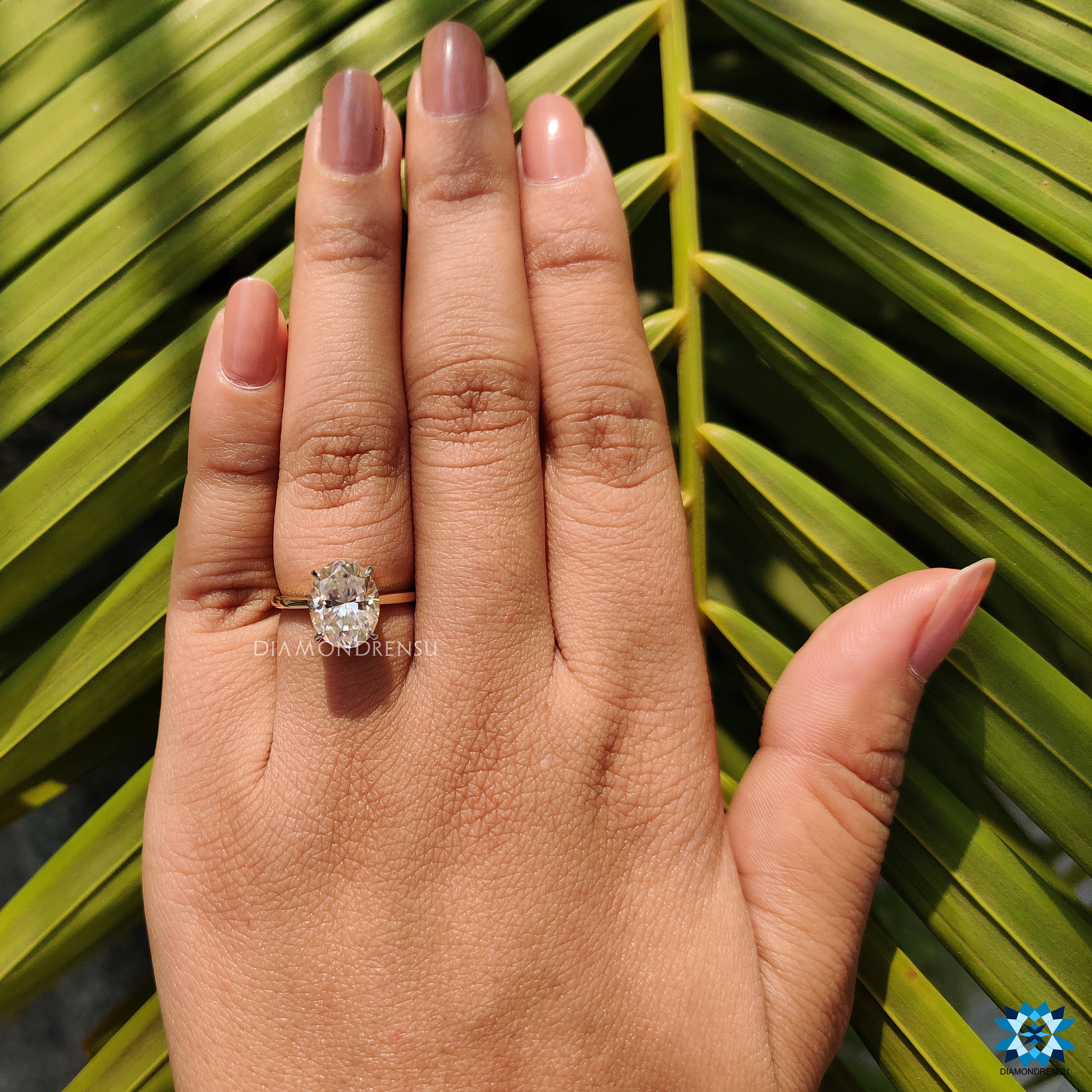 White and yellow gold engagement ring with oval hidden halo setting.