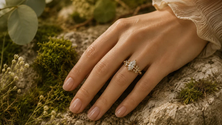 Nature inspired engagement ring worn on hand over moss