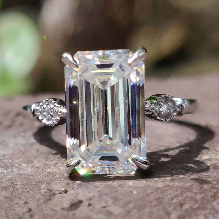 Emerald cut moissanite engagement ring in white gold.
