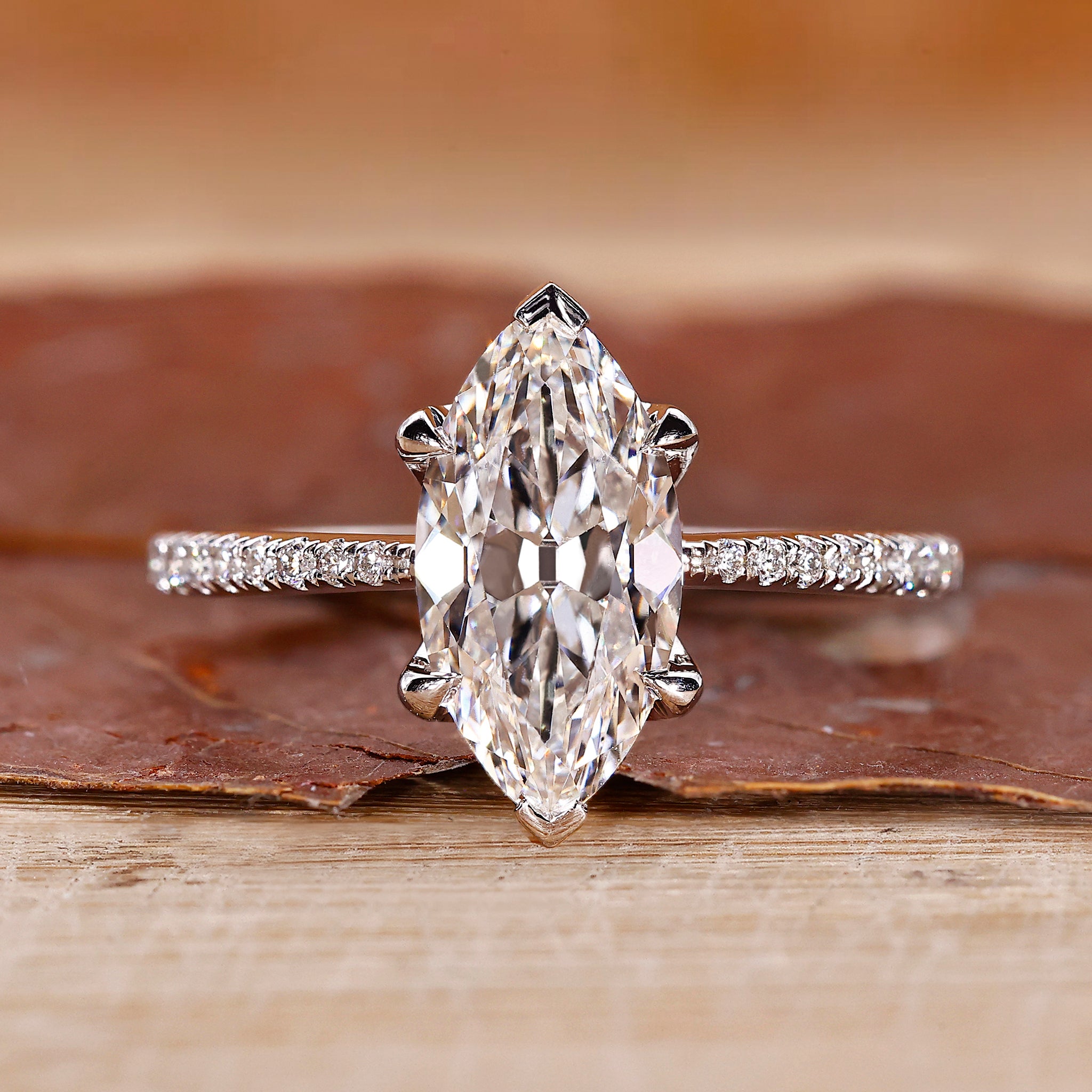 Marquise cut engagement ring with pave setting and white gold band.
