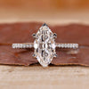 Marquise cut engagement ring with pave setting and white gold band.

