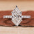 Hidden halo engagement ring with a Dutch marquise diamond.

