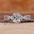 Elongated cushion cut diamond ring with a twisted pavé setting.
