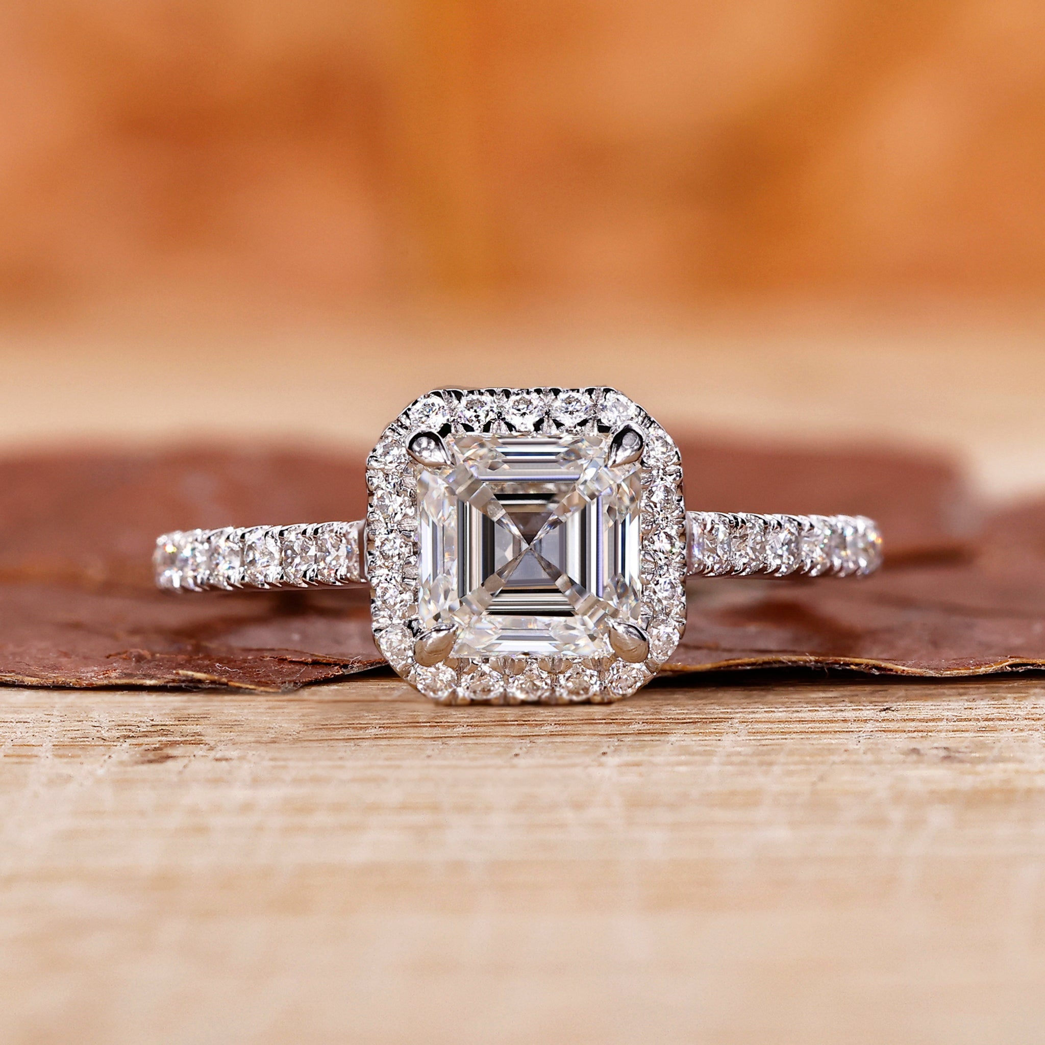 Asscher cut diamond ring with a halo ring setting and accent stones for a unique engagement ring.
