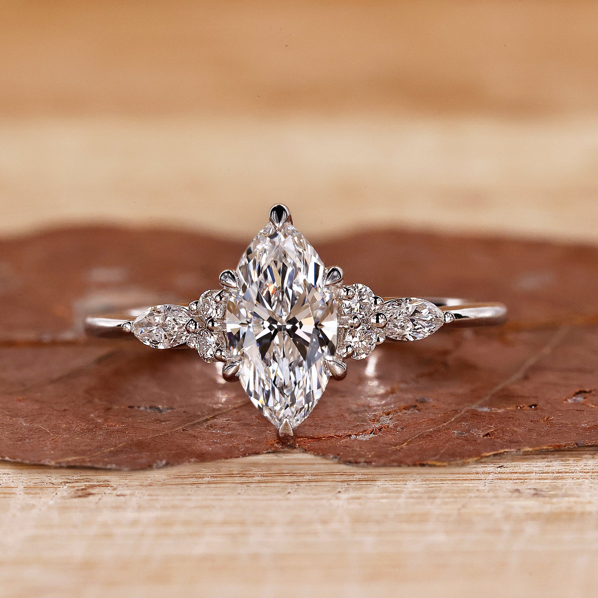 Marquise engagement ring with marquise and round side stones.
