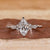 Marquise engagement ring with marquise and round side stones.
