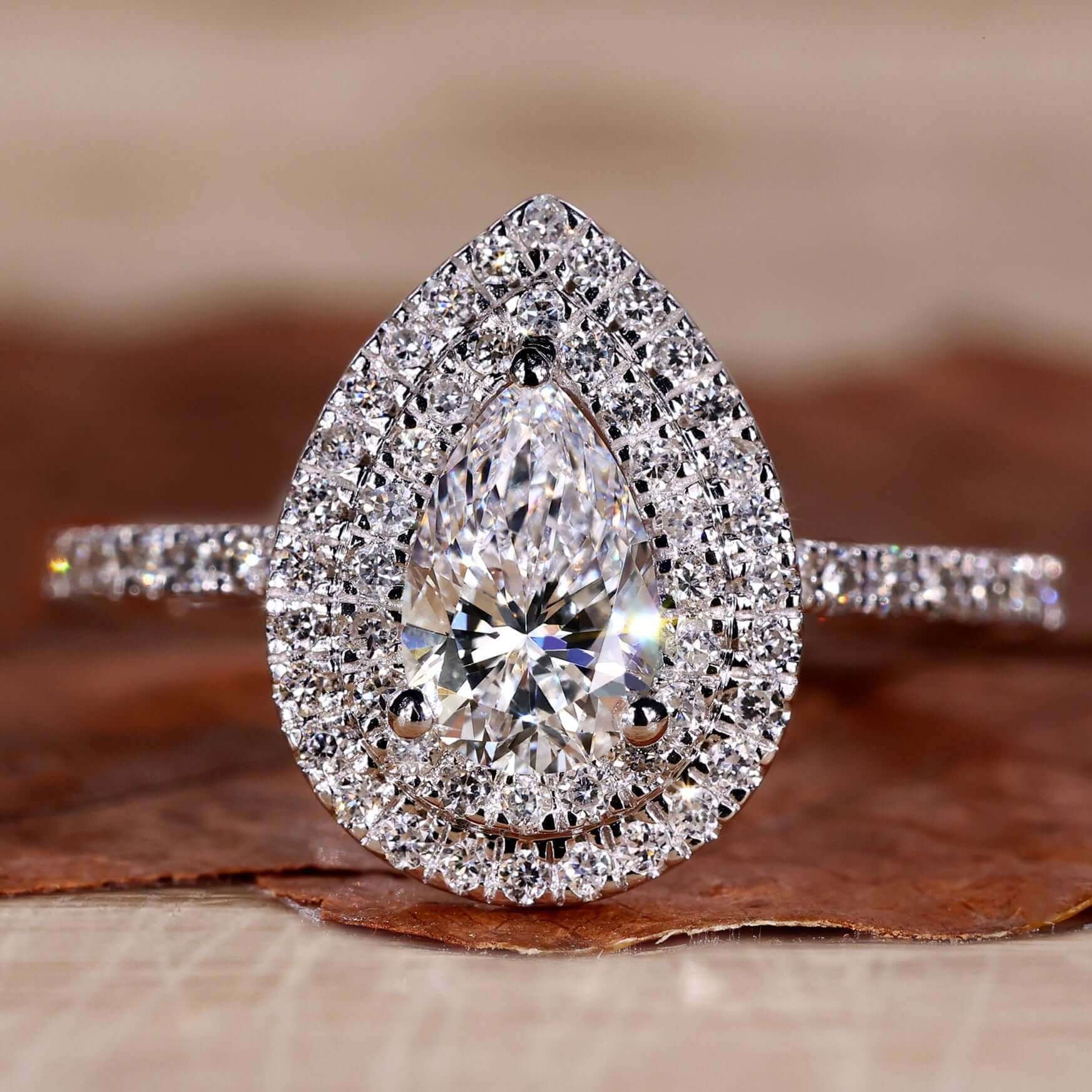 Pear shaped diamond ring with a stunning claw prong engagement ring setting for added elegance.