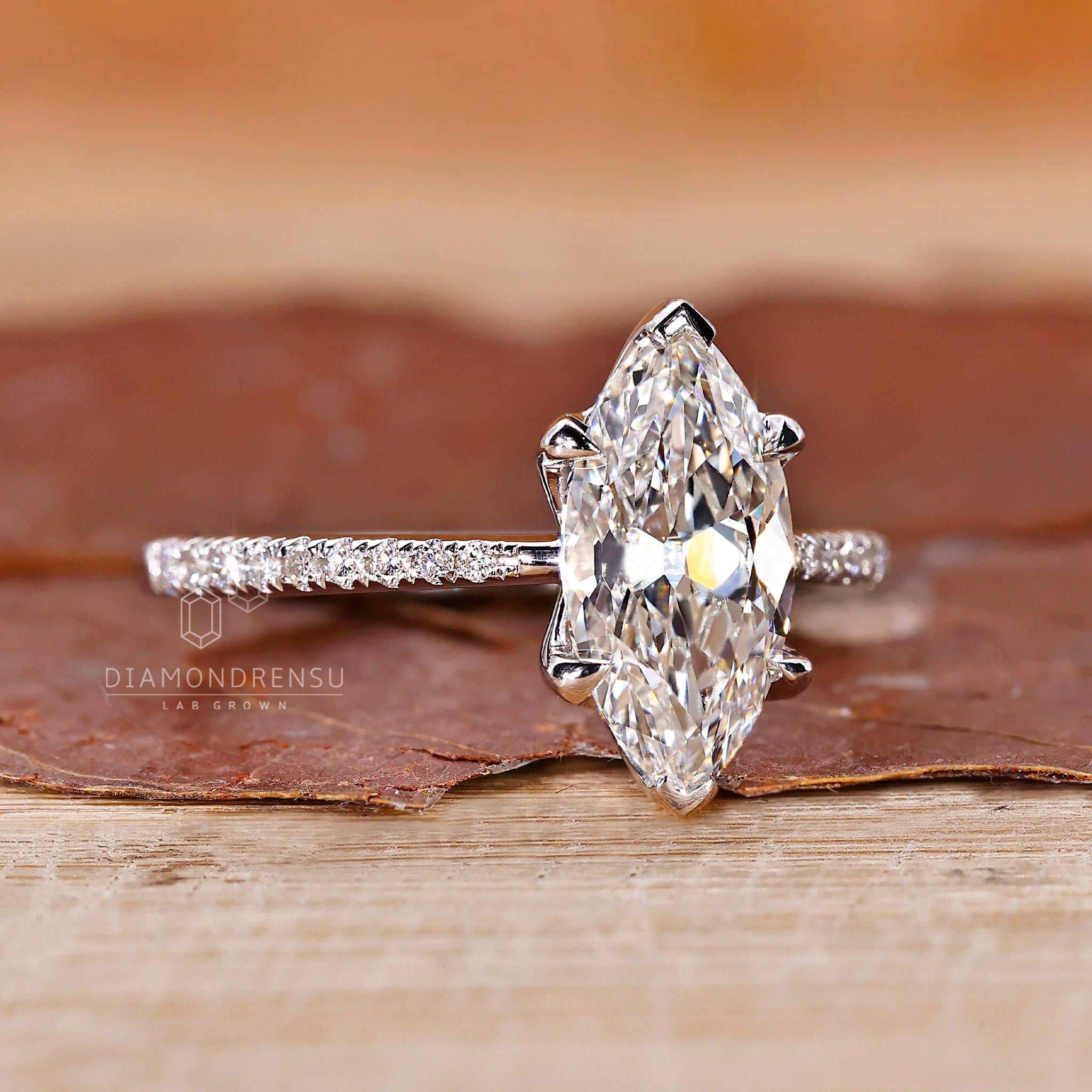 Buy engagement ring online with custom marquise cut diamond design.

